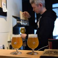 Ben Falck — one of the founders of Kyoto Brewing Co. — pours beers in the brewery\'s tasting room.  | SATOKO KAWASAKI
