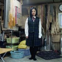 Nibutani, Hokkaido, 2014. Maya, 15 years old, in school uniform at her grandmother’s Attus weaving workshop. Maya was born to an Ainu mother and a Japanese father. Seeing Ainu as they want to be seen