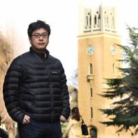 Makoto Watanabe, editor-in-chief of the Waseda Chronicle, a nonprofit investigative journalism organization, poses on the campus of Waseda University in Tokyo, where the unit is based, on March 13. | SATOKO KAWASAKI