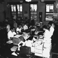 Editorial department staff work in The Japan Times office near JR Shimbashi Station in Tokyo in the early 1960s. The office was not air-conditioned.
