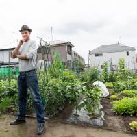 Jon Walsh stands in his community garden patch in Tokyo. | STEVE MORIN