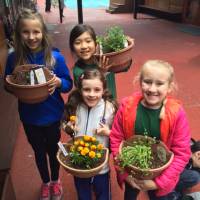 Students show off their newly transplanted seedlings. | COURTESY OF JON WALSH