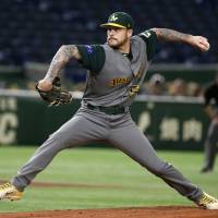 Australia left-hander Travis Blackley pitches against China in the first inning on Thursday. | AP