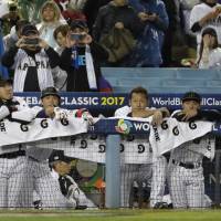 Japan players react to their 2-1 defeat to the United States in the semifinals of the World Baseball Classic on Tuesday at Dodger Stadium in Los Angeles. | AP