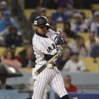 Japan\'s Ryosuke Kikuchi hits a solo home run in the sixth inning of Tuesday\'s WBC semifinal. | AP