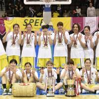 The Jx-Eneos Sunflowers celebrate after beating the Toyota Antelopes in Game 3 of the Women\'s Japan Basketball League Finals on Sunday at Yoyogi National Gymnasium No. 2. | KYODO