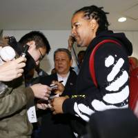 Former major league slugger Manny Ramirez signs autographs for fans after arriving at Narita airport on Tuesday to play for the Kochi Fighting Dogs in the Shikoku Island League Plus. | KYODO