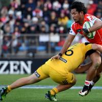 The Sunwolves\' Ryohei Yamanaka is tackled by Dane Coles of the Hurricanes during their match on Saturday. | AFP-JIJI
