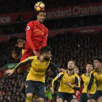 Liverpool\'s Joel Matip jumps for a header during the Reds\' 3-1 win over Arsenal at Anfield on Saturday. | AFP-JIJI