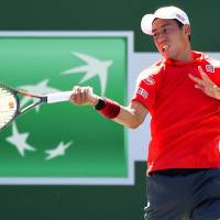 Kei Nishikori plays a shot during his second-round win over Daniel Evans at the BNP Paribas Open on Sunday. | KYODO