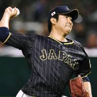 Japan starter Tomoyuki Sugano pitches against a Taiwanese all-star team during an exhibition game on Wednesday in Fukuoka. | KYODO