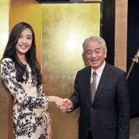 Brunei\'s Charge d\'Affaires a.i. Jessica Tiah (left), welcomes Secretary General of the Asean-Japan Centre Masataka Fujita during a reception to celebrate the country\'s 33rd national day anniversary at the Hotel New Otani, Tokyo on March 3. | YOSHIAKI MIURA