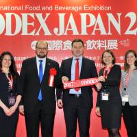 (from left) Galina Meilunas, wife of the Lithuanian ambassador to Japan; Lithuania\'s acting Director of State Food and Veterinary Service Deividas Kliucinskas; Lithuania\'s Vice Minister of Agriculture Rolandas Taraskevicius; and others pose after the Foodex Japan 2017 ribbon-cutting ceremony. | YOSHIAKI MIURA