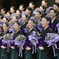 Students of the all-female Takarazuka Music School in Takarazuka, Hyogo Prefecture, pose after graduating from the two-year program in music and dancing on Thursday. They will debut at the Takarazuka Revue on April 21. | KYODO