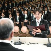 Nozomi Sugita, a 22-year-old worker for Ito-Yokado Co., pledges her efforts to meet customer demand on behalf of all other new employees at a ceremony in Tokyo on Thursday. The event was held by retail giant Seven &amp; I Holdings Co. for new staff at 22 group companies, including Ito-Yokado. | KYODO