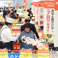 Shoppers browse items in a shopping mall in Tomioka, Fukushima Prefecture, after it re-opened on Thursday ahead of the partial lifting of an evacuation order in place for the area since March 11, 2011. The evacuation order will be lifted Saturday for about 9,600 town residents. | KYODO