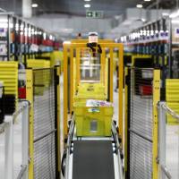 Amazon Japan G.K. is expanding its same-day delivery service to include cooked meals and other items. | BLOOMBERG
