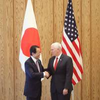 Deputy Prime Minister Taro Aso greets U.S. Vice President Mike Pence ahead of their economic dialogue at the Prime Minister’s Office in Tokyo on Tuesday. Bilateral free trade pact with Japan a possibility, Pence says