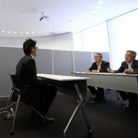 A student undergoes an interview at a job fair in Tokyo in 2014. Knocking, 'recruit suits' and bowing: Etiquette key for Japan's job-seekers