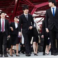 University students head toward a job fair in the city of Chiba in March. Japan's top three brokerages to pare grad hiring as households shun stocks