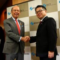 U.S. Commerce Secretary Wilbur Ross is welcomed by trade minister Hiroshige Seko at the start of their talks in Tokyo Tuesday. | REUTERS