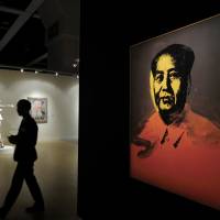 A man walks past the painting “Mao” by U.S. pop artist Andy Warhol during a media preview for the Sotheby’s Modern and Contemporary Art Evening Sale in Hong Kong Friday. The painting of Chairman Mao Zedong fetched $12.7 million Sunday. Warhol's Mao portrait falls short of expectations, fetches $12.7 million in Hong Kong auction