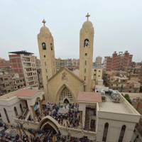 People gather outside the Mar Girgis Coptic Church in the Nile Delta City of Tanta, about 100 km north of Cairo after a bomb blast struck worshipers celebrating Palm Sunday. Bomb attacks on Egyptian churches by Islamic militants kill at least 36 people
