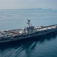 The U.S. aircraft carrier USS Carl Vinson transits the Sunda Strait, Indonesia on Saturday. | SEAN M. CASTELLANO / COURTESY U.S. NAVY/HANDOUT / VIA REUTERS