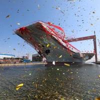 China\'s first domestically built aircraft carrier is seen during its launching ceremony on Wednesday in Dalian, Liaoning province. | REUTERS