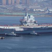 China\'s first domestically built aircraft carrier is seen during its launching ceremony in Dalian, Liaoning province, on Wednesday. | REUTERS