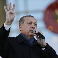 Turkish President Recep Tayyip Erdogan delivers a speech during a rally of supporters a day after the referendum, outside the Presidential Palace, in Ankara Monday. Turkey’s main opposition party urged the country’s electoral board Monday to cancel the results of a landmark referendum that granted sweeping new powers to Erdogan, citing what it called substantial voting irregularities. Trump ignores State Department warning, congratulates Turkey's Erdogan after contentious poll win