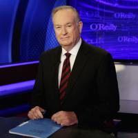 Host Bill O\'Reilly of \"The O\'Reilly Factor\" on the Fox News Channel poses for photos in in 2015 on the set in New York.  President Donald Trump defended O\'Reilly Wednesday, claiming he didn\'t commit sexual harassment as has been widely reported. | AP