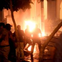 Hundreds of demonstrators protesting against the approval of a constitutional amendment for presidential re-election broke into Paraguay\'s Congress building in Asuncion on Friday, battering down entrances and fences and shattering windows, and started to set fires inside. | AFP-JIJI