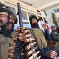 Members of the Iraqi security forces rest in the old city of Mosul on Sunday as part of the offensive to recapture the city from Islamic State group fighters. | AFP-JIJI