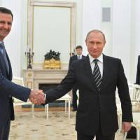 Russian President Vladimir Putin (center) meets with Syrian President Bashar Assad as Russian Foreign Minister Sergey Lavrov looks on in the Kremlin in Moscow in 2015. U.S. Secretary of State Rex Tillerson\'s statement Tuesday that the reign of President Bashar Assad\'s family \"is coming to an end\" suggests Washington is taking a much more aggressive approach about the Syrian leader. Taking him out of the equation without a clear transition plan would be a major gamble. | ALEXEI DRUZHININ, SPUTNIK, KREMLIN POOL PHOTO / VIA AP, FILE