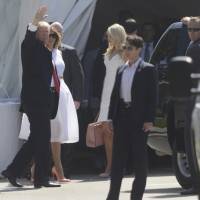 President Donald Trump, accompanied by first lady Melania Trump, waves to onlookers as he enters Episcopal Church of Bethesda-by-the-Sea in Palm Beach, Florida, for an Easter Service Sunday. Trump and family take in Easter church service
