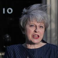British Prime Minister Theresa May speaks to reporters outside No. 10 Downing St. on Tuesday. | AFP-JIJI