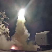 The guided-missile destroyer USS Porter conducts a strike against a Syrian airfield from the Mediterranean Sea on Friday. | AFP-JIJI