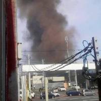 Black smoke is seen rising from a factory in Asahikawa, Hokkaido, on Tuesday in this photo provided by a resident who lives nearby. | KYODO