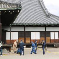 Investigators search the Ninomaru Palace in Kyoto, where what apparently was curry power, was found scattered around various locations at the site on Tuesday. | KYODO