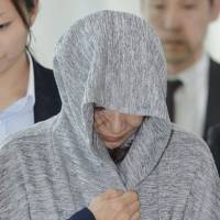 Setsuko Yamabe, who allegedly ran an illegal multimillion-yen pyramid investment scheme and was escaping to Thailand, arrives at Tokyo\'s Haneda airport on Wednesday. KYODO | AFP-JIJI