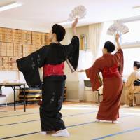 Hiroko Sawada (left) teaches Japanese traditional dance to her students in Sapporo on March 2. | KYODO