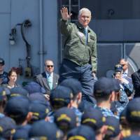 U.S. Vice President Mike Pence waves during a visit to the USS Ronald Reagan aircraft carrier at the U.S. Naval base in Yokosuka, Kanagawa Prefecture, on Wednesday. | AFP-JIJI