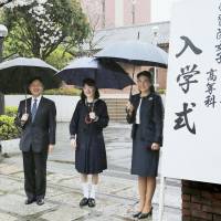 Princess Aiko, accompanied by Crown Prince Naruhito and Crown Princess Masako, poses for a photo during the entrance ceremony for Gakushuin Girls’ Senior High School in Tokyo on Saturday. | POOL / KYODO