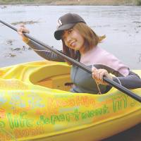 Megumi Igarashi paddles a kayak in October 2013 designed in the shape of her vagina. | AFP-JIJI