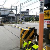 Two men died Saturday after they were struck by a Keikyu train at this level crossing at Hatcho-nawate Station in Kawasaki. | KYODO