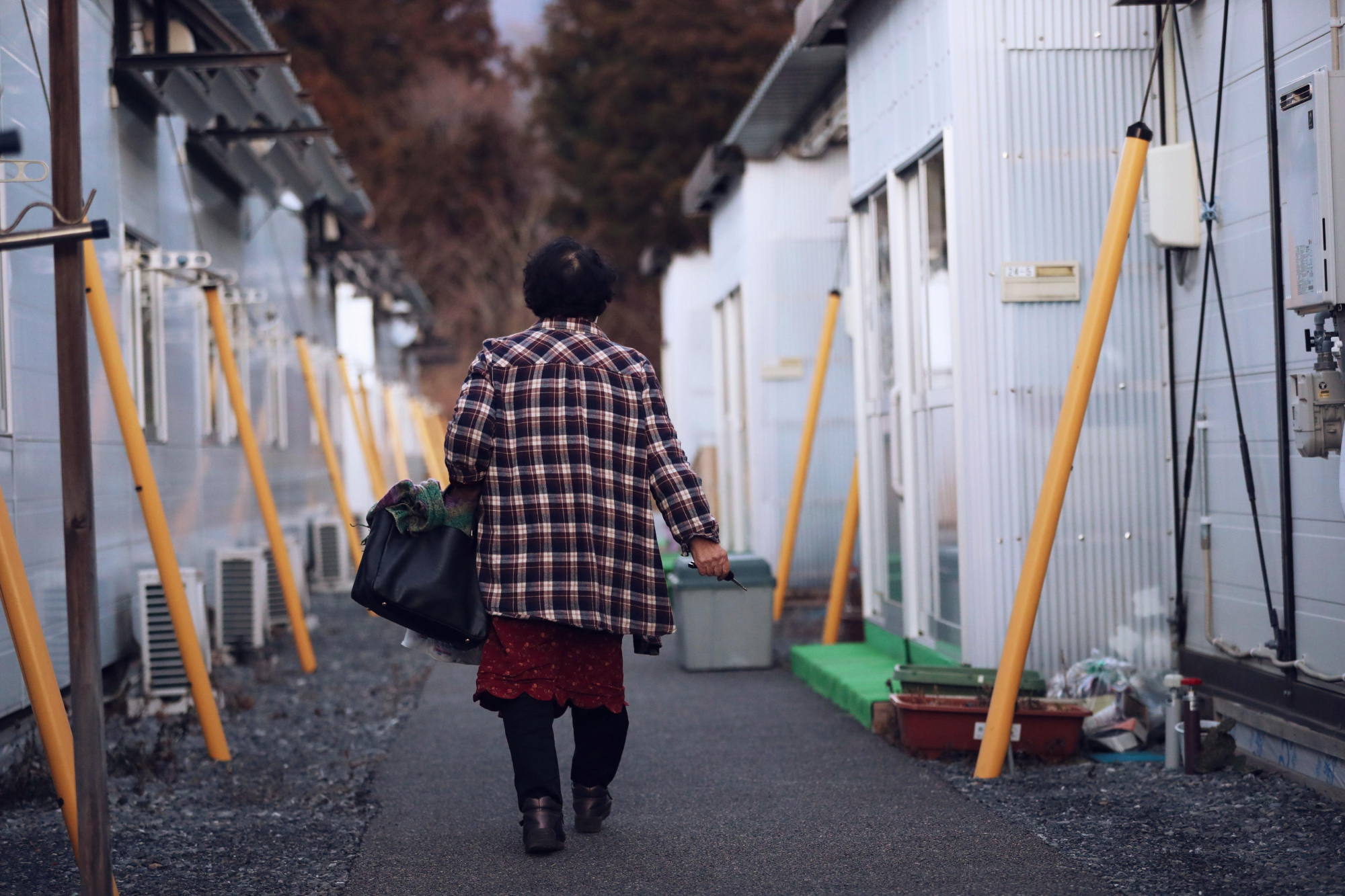 The long stopgap: A woman visits her son, who is still living in temporary housing in Ofunato, Iwate Prefecture. | KYODO