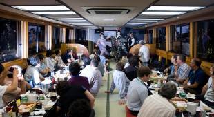 Customers enjoy entertainment aboard a yakatabune pleasure boat in 2010.