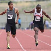 Aska Cambridge (left) crosses the finish line in the 100 meters at the NTC/Pure Athletics Spring Invitational in Cleremont, Florida, on Sunday. | KYODO