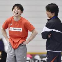 Kohei Uchimura (left) enjoys a light moment during a Thursday workout. | KYODO